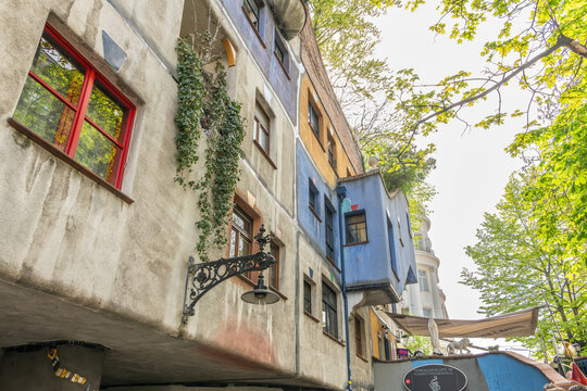 15 April 2026, Vienna, Austria. Hundertwasser House facade detail with lamp and ivy