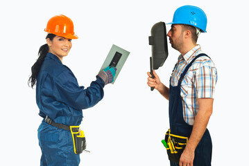 Fototapeta premium Two builders wear helmets and tools