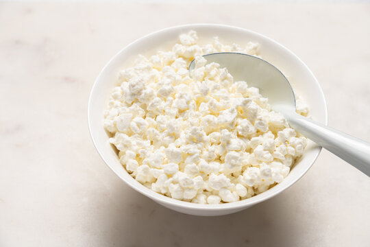 Cottage cheese in bowl as healthy protein breakfast base on light background