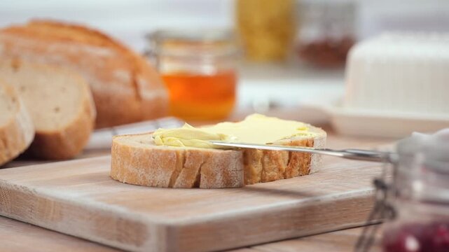 Butter spreading on fresh bread slice, close up homemade breakfast scene, copy space