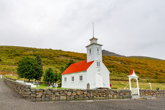 Small white church with a red roof on a hill, Lauf?s heritage site, Grass-roofed houses and church from 19th century offer insights into early Icelandic life. Northern Iceland