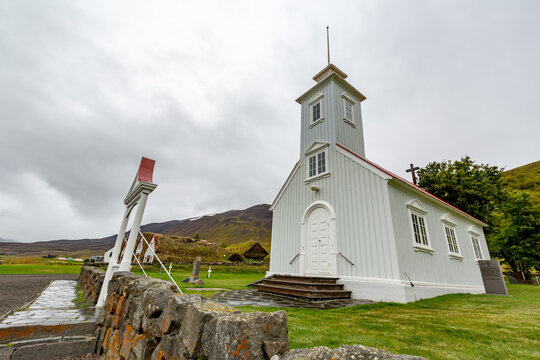 Small white church with a steeple on the side, Lauf?s heritage site, Grass-roofed houses and church from 19th century offer insights into early Icelandic life. Northern Iceland