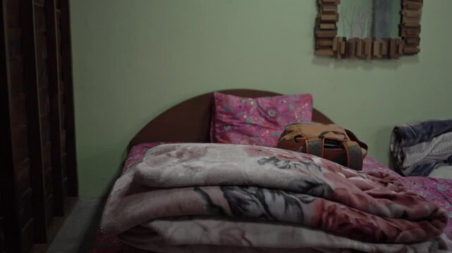 A serene bedroom setting featuring a plush bed covered in soft textiles, highlighting a warm and inviting atmosphere. The muted color palette and soft lighting create a tranquil space perfect for rela