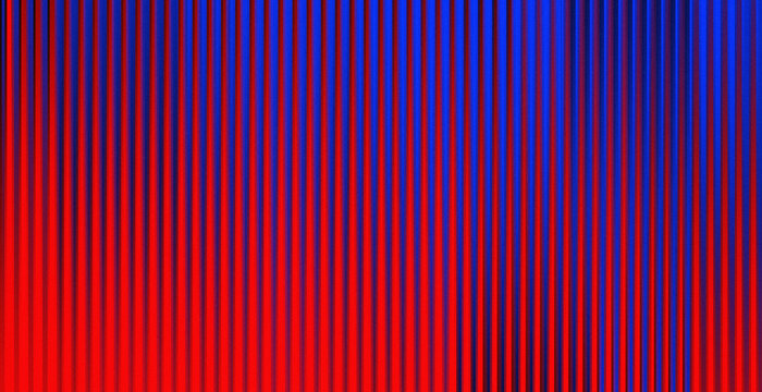 Vertical lines glow with red and blue hues. Light casts deep shadows across the surface. Pattern feels modern, bold, and energetic. Suitable for digital design or tech backgrounds