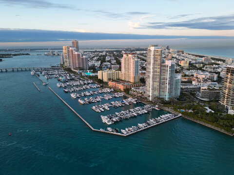 Yacht docked at Miami marina. Aerial view of coastline in Miami. Miami skyline above harbor. Famous Miami Beach marine from above. Marina with yachts.
