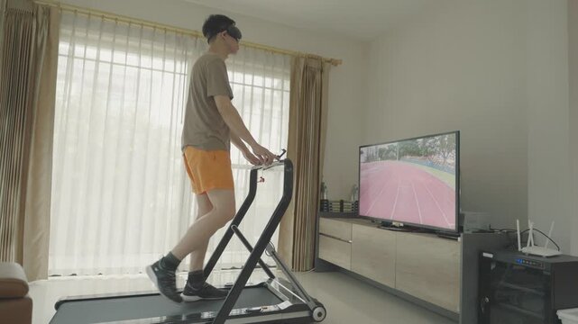 A person exercising on a treadmill at home while watching a virtual running track on TV. This setup promotes fitness and a healthy lifestyle through convenient indoor workouts.