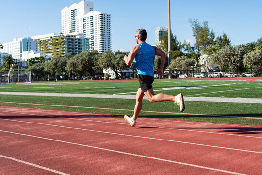 Sport training. Man sportsman running for exercise. Man running at racetrack outdoor. Runner sprinted with incredible speed. Sport runner completing a marathon, banner