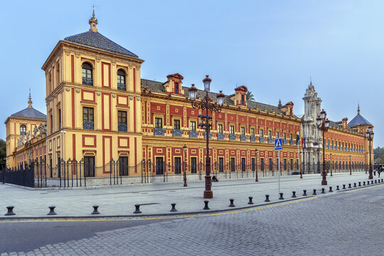 Baroque facade of Palace of San Telmo in Seville Spain. Historic building with ornate stone portal under clear blue sky