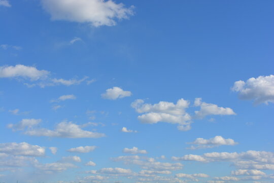 Bright nice weather, relaxation, entertainment, beauty, freedom. A beautiful blue sky with fluffy white clouds floating over the river.