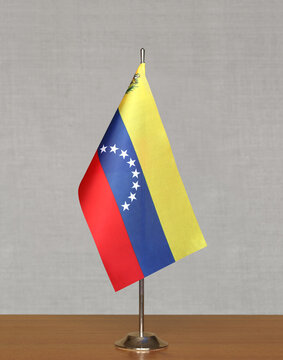 Table flag Venezuela on a blurred gray background