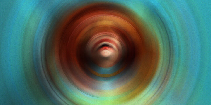 Hypnotic circular motion blur background with radial swirl of teal orange and red colors around central abstract focal point.