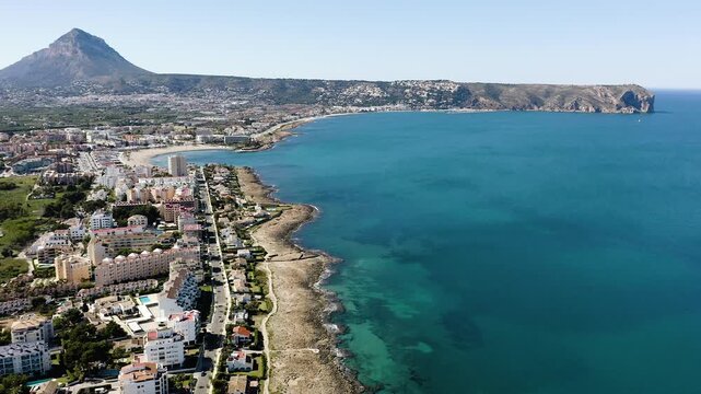 Aerial view of Arenal sand beach and rocky coast around in J&aacute;vea, Alicante, Spain. With calm waters surrounded by urban coastal landscape. 