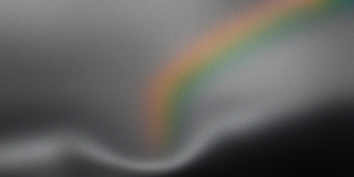 Prismatic rainbow arc on grainy grey background with soft white vapor wave and ethereal light diffusion for modern art design.