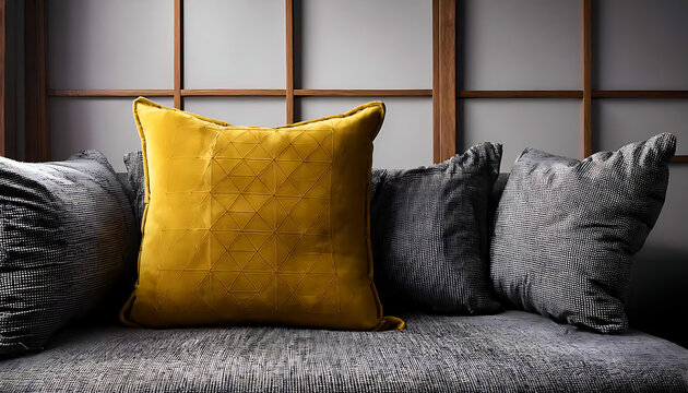 Gray couch with yellow and gray cushions on wooden frame wall