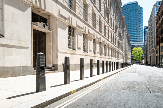 Dramatic view of a line of security bollards located outside a central London government building in Pimlico. The bollards act as perimeter security for unauthorised vehicles in the area.