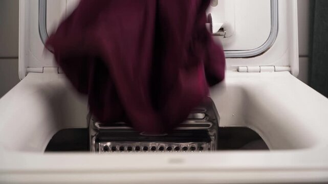 Filling top loading washing machine with clothes