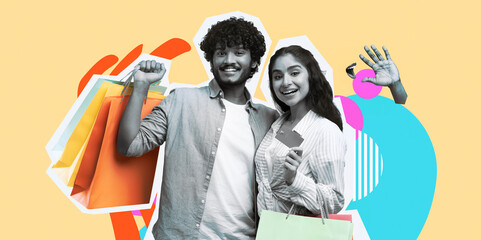 Indian couple stands against a yellow background, showing a debit card and holding shopping bags after shopping at the mall. They smile and enjoy their purchase experience. © Prostock-studio