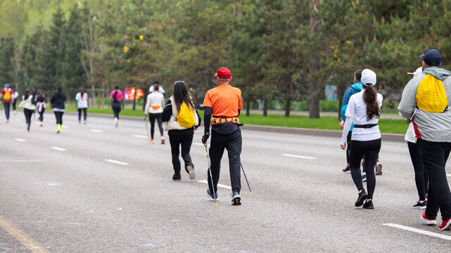 Diverse participants jogging and Nordic walking at Almaty Half Marathon 2026