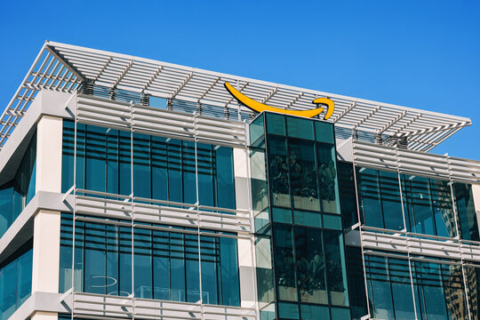 14 January 2026, Dubai, UAE: Amazon corporate headquarters building displaying its yellow smile logo under a clear blue sky, symbolizing global commerce