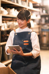 Woman tablet apron cafe smiling worker restaurant service uniform inventory © chokniti
