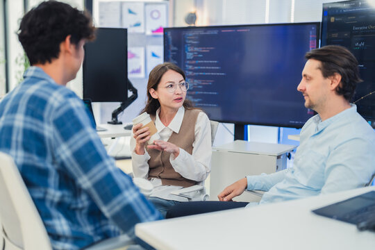 Professional Female Specialist Explaining Advanced AI Neural Network Data to Tech Team in Modern Office