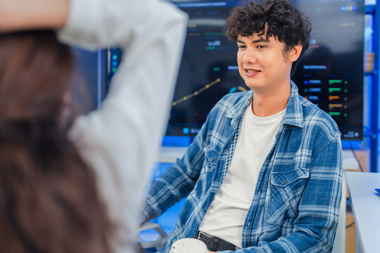 Happy Young Male Developer Discussing Project Strategy with Colleague in Modern AI Tech Office