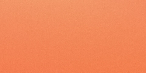 Fototapeta premium A close up view of a vibrant peach-orange paper surface, showcasing its subtle grainy texture and uniform color.