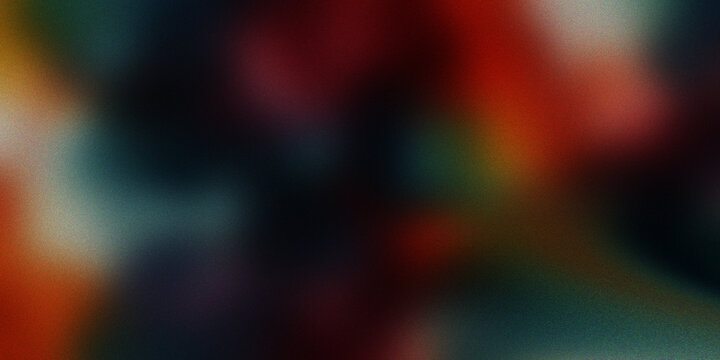 Abstract grainy background with a soft blend of red, green, blue, and orange hues creating a vibrant color spectrum.
