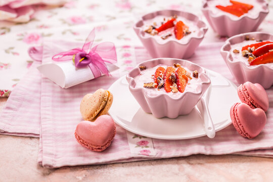 Strawberry curd cream with pink heart shaped macarons and sparkling wine for Mother's Day brunch