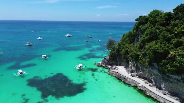 Drone aerial footage of tropical beach in Boracay with clear blue ocean and white sand coastline