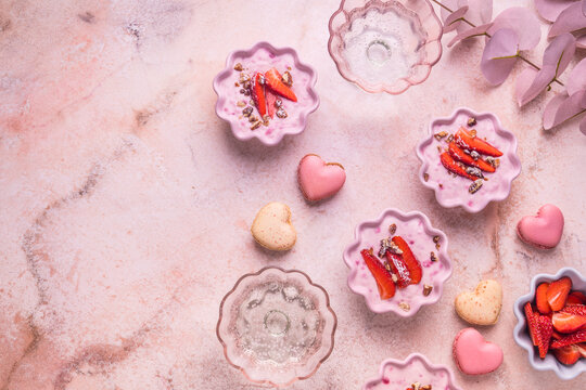 Strawberry curd cream with pink heart shaped macarons and sparkling wine for Mother's Day brunch