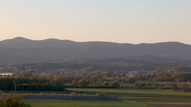Evening panorama of Winzer Bavaria with rolling hills rural houses and golden sunset landscape view