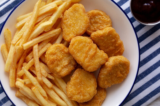 Chicken Nuggets with Fries on a Plate, top view. Close-up.