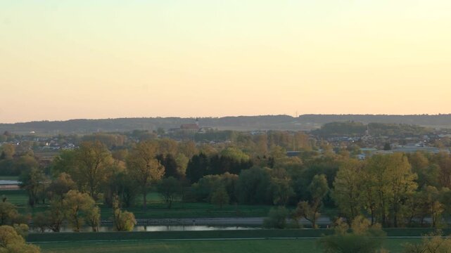 Evening panorama of Winzer Bavaria with rolling hills rural houses and golden sunset landscape view