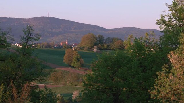 Evening panorama of Winzer Bavaria with rolling hills rural houses and golden sunset landscape view