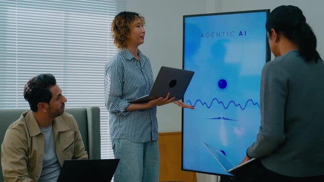 Developer team meeting for planning and developing Voice assistant and Agentic AI program. Professional software engineers using laptop and smart screen for system analytics in modern tech office