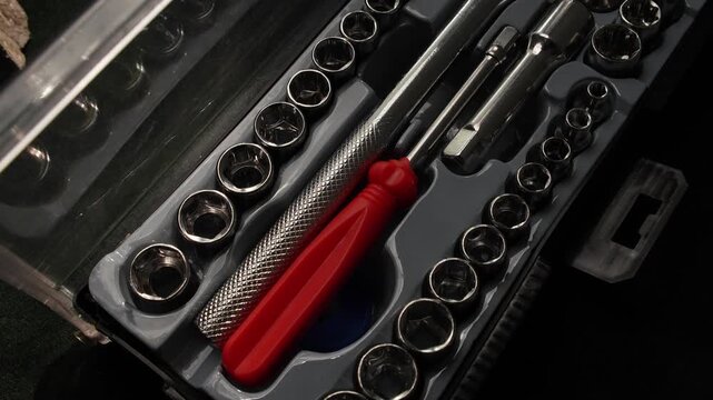 Organized socket wrench set in case with metal tools and accessories