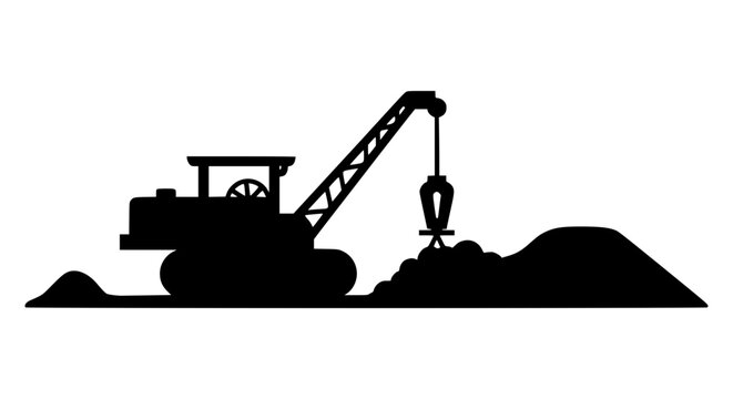 Silhouette of a crawler crane excavator working on a pile of dirt