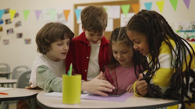 Multiracial classmates discussing ideas for group project using tablet device