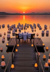 Fototapeta premium Romantic table for two is set on a wooden dock surrounded by glowing lanterns on a calm lake at sunset.