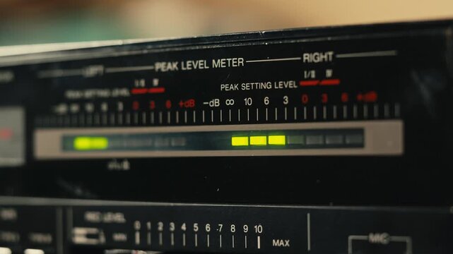 Retro radio tape recorder, audio cassette close-up. Listening to music, old radio boom box player, macro of vintage music listening. 
