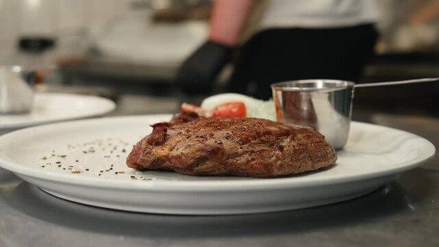 Beef angus steak in restaurant, close up Pieces of hot ribeye steak served on the wooden board. Medium steak slices with blood, salt and pepper in fancy meat cafe. 