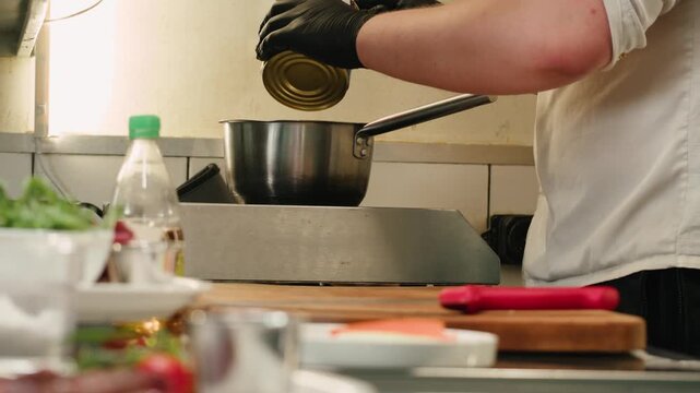 Working with beef, cut steak Chef cooking Raw beef meat tartar with sauce, man cutting steak tartare, making delicious french dish in modern restaurant. Fresh eco angus meat. 