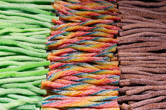 Arrangement of sweets on a market stall, showing candy laces and liquorice.