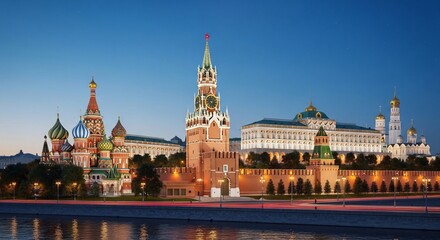 Fototapeta premium The Kremlin and Red Square in Moscow at dusk with colorful domes and towers illuminated against a clear blue sky