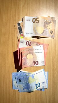 Hands counting euro banknotes