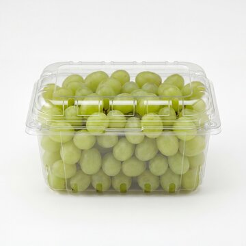fresh green seedless grapes in clear plastic clamshell container on white background