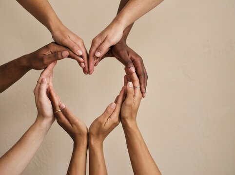 A circle of diverse hands creating a heart shape, symbolizing unity and collaboration.