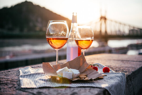 Glasses of rose wine in summer sunshine during a outdoors party or a picnic.