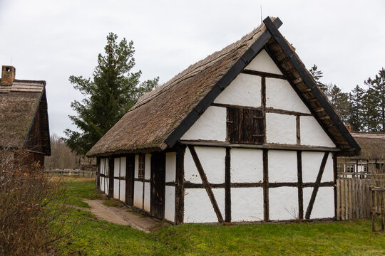 Traditional half timbered house with thatched roof in Kluki, Poland.